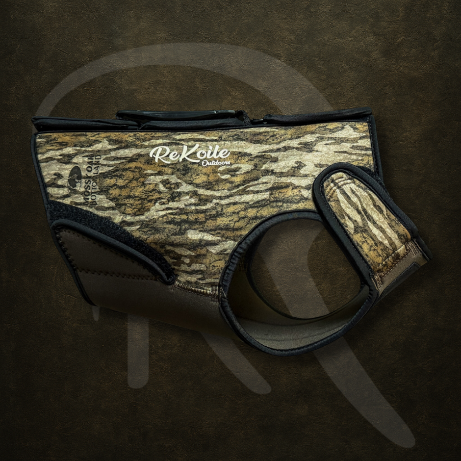 Mossy Oak Bottomland dog vest with ReKoile logo on a dark background
