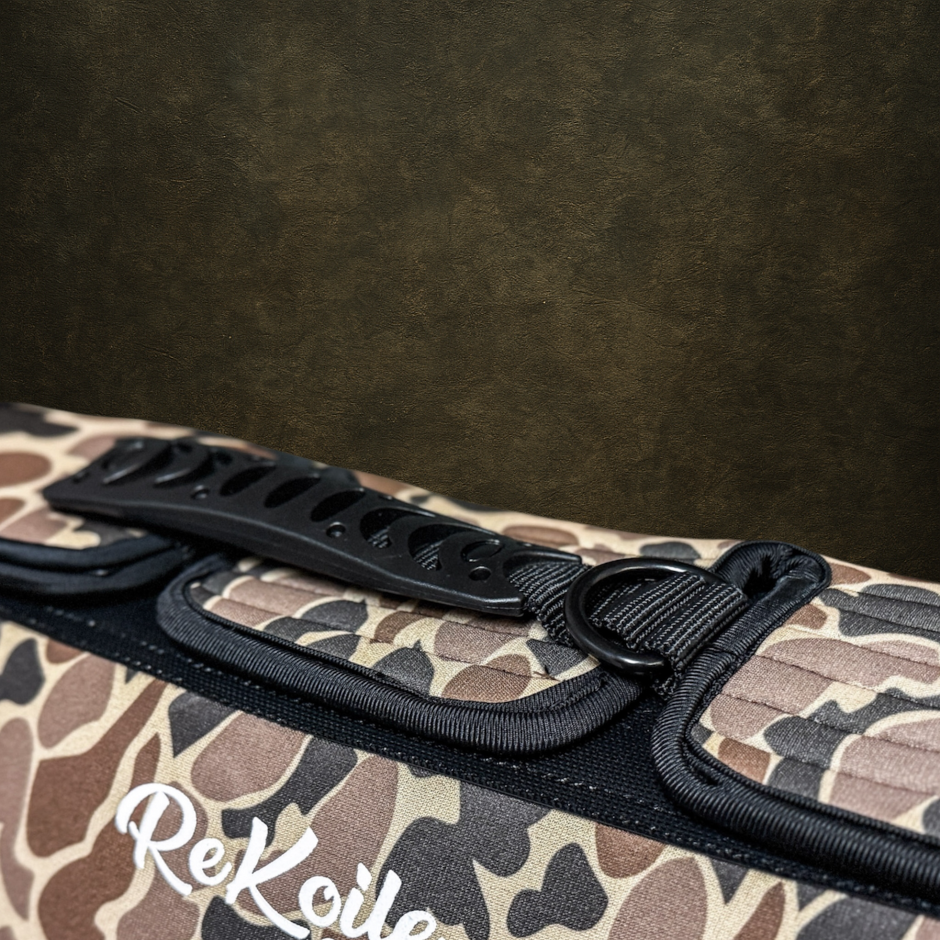 Camouflage-patterned dog vest with exposed handle and 'ReKoile' branding on a dark background