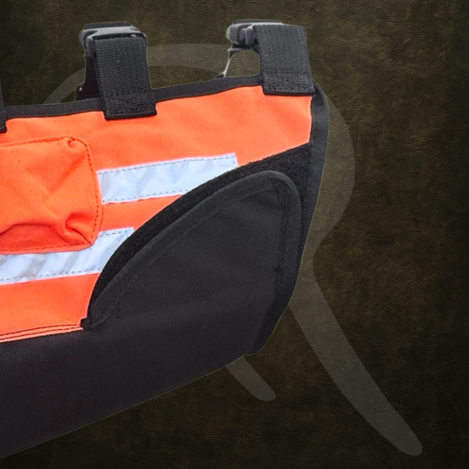Orange and black dog safety vest on a dark background highlighting the waist adjustment