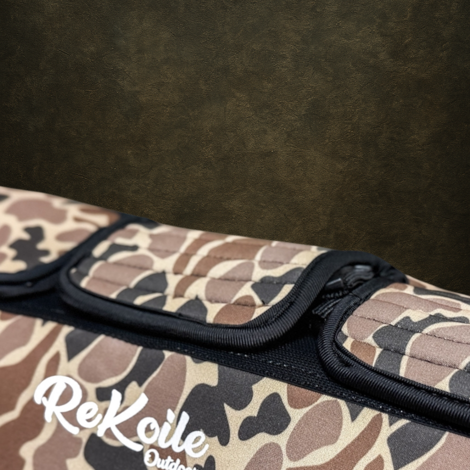 Camouflage-patterned dog vest with a hidden handle with ReKoile branding on a dark background