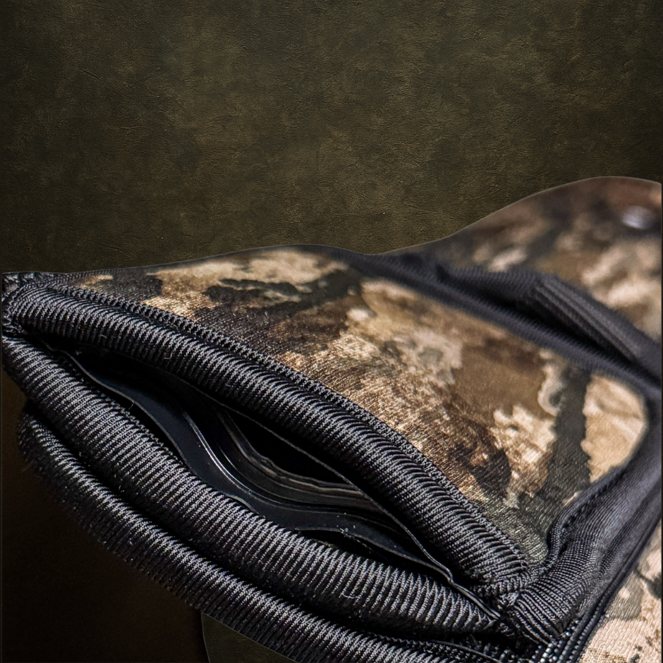 Close-up of a camouflage-patterned dog vest with hidden gps pocket on a textured brown background