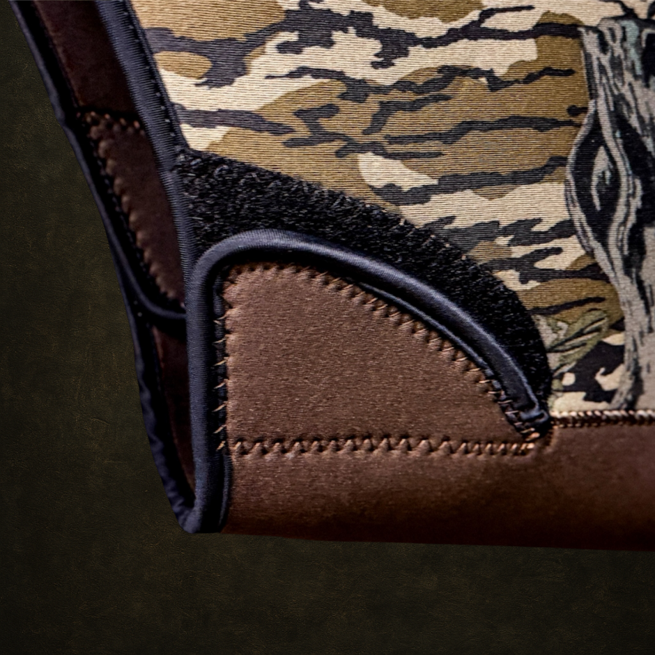 Camouflage-patterned dog vest waist adjustment with brown accents on a dark background
