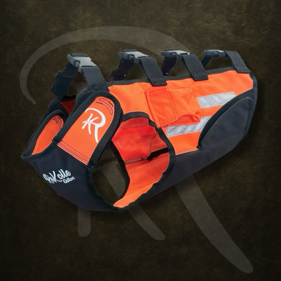 Orange and black dog harness with reflective strip on a dark background